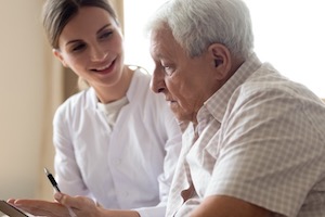 Nurse speaking to elder man