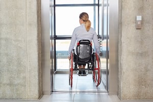 Lady on wheel chair using elevator